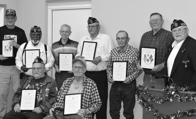 AMERICAN LEGION POST 119 IN ST. PAUL presented certificates for continuous membership at their American Legion Birthday Party last month. Honorees included (front row): Albert Zimbleman, seventy years, and Donald Knapp, fifty years; (back row): Gerald Schenck, fifty-five years; Jack McMillon, fifty years; Laverne Hansel, fifty years; Bryce Pearson, sixty years; Gale Lassen, fifty years; Jerald Hirschman, fifty-five years; and Post Commander Chuck Schmid. Courtesy Photo