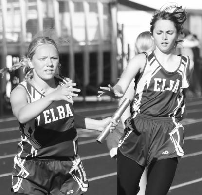 ELBA’S Addison Wysocki takes the baton from Alana Berney to begin the last leg of the girls’ 4x400-meter run during last Wednesday’s district track meet in Fullerton. Photos by Michael Happ