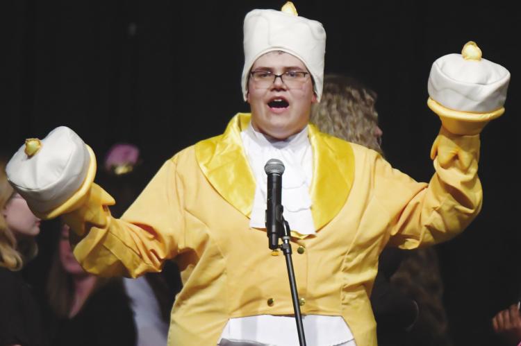 JOSEF KASLON was the Candlestick during a performance of Be Our Guest, which was the opening number of St. Paul High School’s variety show on Saturday night. Photos by Michael Happ