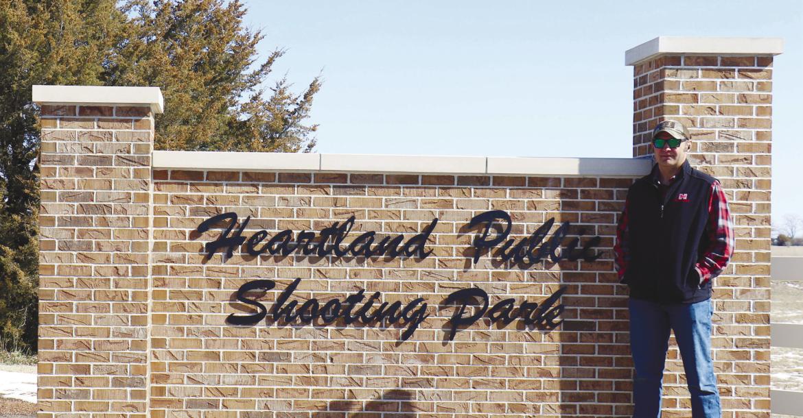 TOM BUSCH is pictured in front of the sign at the Heartland Public Shooting Park near Grand Island last week. Busch recently stepped down as Howard County’s sheriff following fifteen years with the sheriff’s office. Photo by Michael Rother