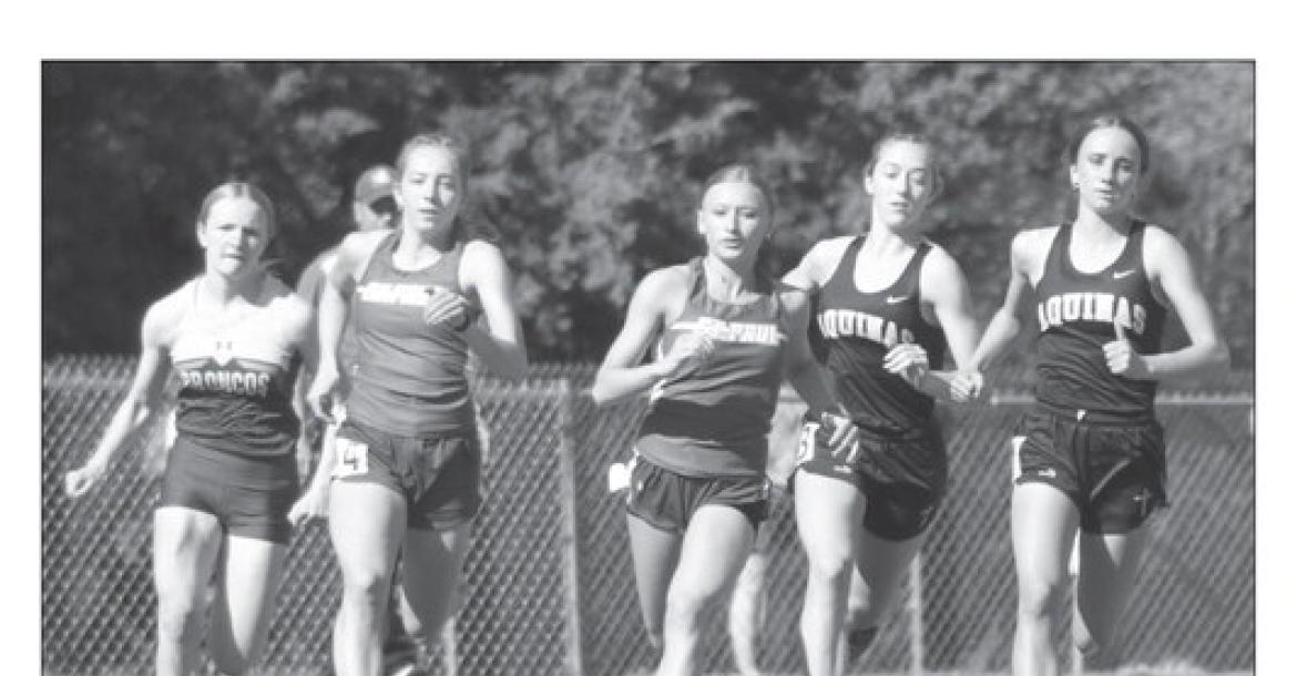 ST. PAUL’S Natalie Poss and Kamden Sack race away at the start of the girls’ 800-meter dash during last week’s district track meet at Centennial High School.