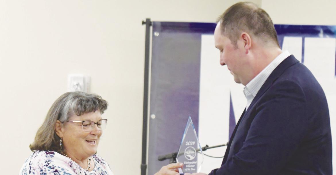 JULIE DUSH, who was honored as the St. Paul Area Chamber of Commerce’s Volunteer of the Year, receives her award from St. Paul Chamber Board President Jake Lawver. Photos by Michael Happ