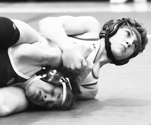 ST. PAUL’S LAYNE BAKER went the distance against Harrison Reed of Minden during last week’s dual between the Wildcats and the Whippets. Beker won the match by a 6-2 decision. Photos by Jordan Coslor