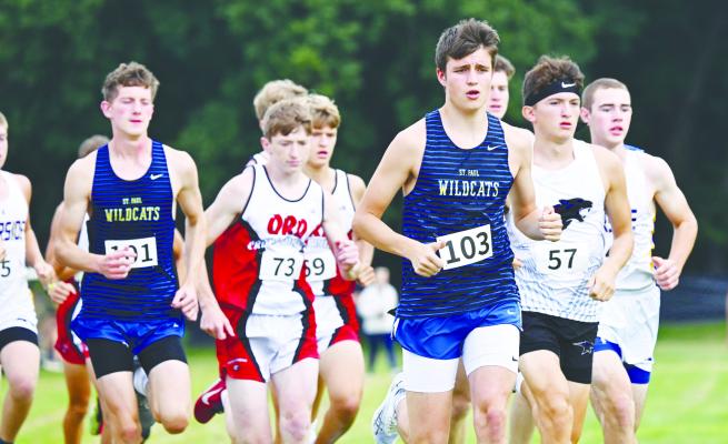 ST. PAUL sophomore Eli Sladek jumps out to the front of the pack following the start of the boys’ race at the St. Paul Invitational last week. Sladek finished the meet sitting in fifth place. Photos by Michael Happ