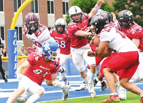 OUT OF THE CORNER SLOT, St. Paul’s Rylan Birkby attempts to thwart a two-point-conversion from the South squad’s JaReese Lott-Buzby of Lincoln High on Saturday evening during the 64th Nebraska Shrine Bowl played in Kearney. (Jordan Coslor)