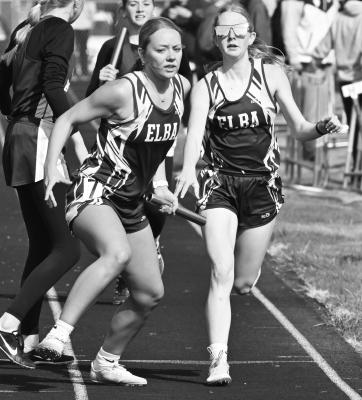 ADDISON WYSOCKI takes the baton from Lacey Barg during the girls’ 1600-meter relay at last week’s Fullerton Invite. Photos by Michael Happ