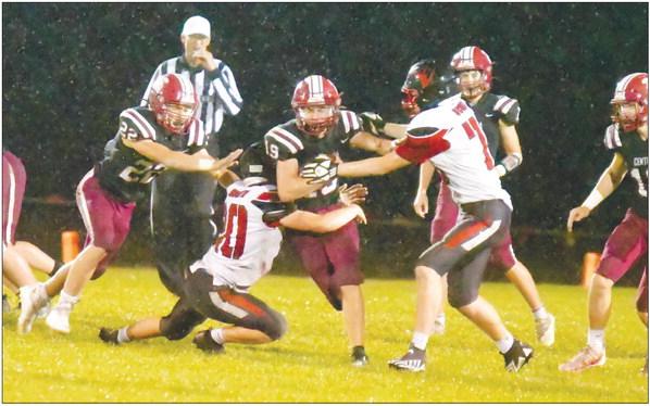 CALVIN ZIMMERMAN finds a hole in the Scouts’ defense on Friday night. Zimmerman carried the ball for 200 yards in the Centurions’ 36-0 victory over David City. Photos by Michael Happ