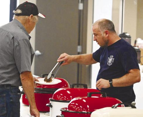 HELPING MAN THE SERVING LINE during Sunday morning’s pancake feed at the St. Paul Civic Center was Steven Brumbaugh. Numerous members of the department lent a hand with the annual fundraiser. Photos by Michael Happ