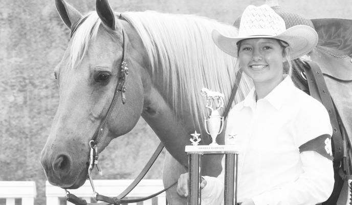 ALLI DUGAN, and her AQHA gelding, Lenas Diamond Doc, were the champions in the Working Ranch Horse competition and were the reserve champions in the Western Riding class at the Fonner Park State 4-H Horse Expo. Alli is the daughter of Kim and Tyler Dugan of St. Paul. Photo by Faye Zmek Photography