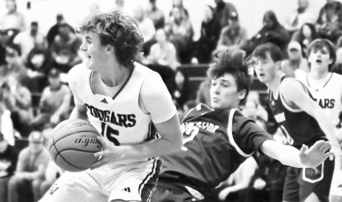 CENTRAL VALLEY’S ZEVAN WOLF fights for a rebound during last Thursday night’s subdistrict final game against Riverside in Greeley. Photos by Michael Happ