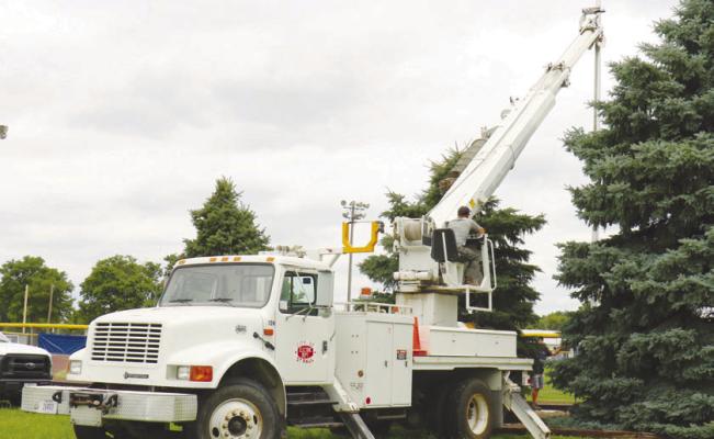 CREWS WITH THE CITY OF ST. PAUL worked to install a new flagpole at Grover Cleveland Alexander Field in St. Paul last Monday afternoon. The new flagpole stands thirty-five feet tall. Photos by Michael Rother