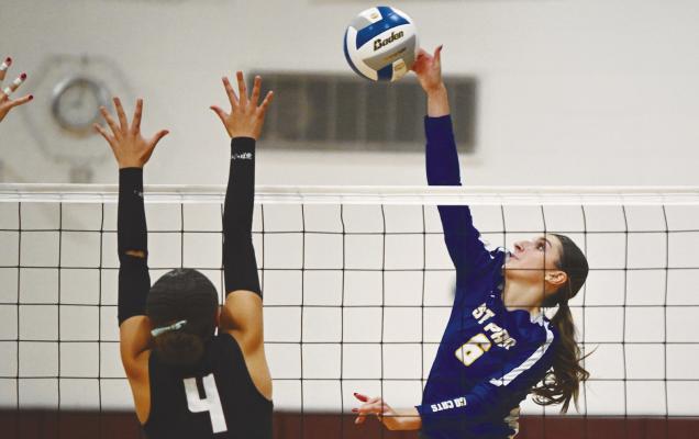 ST. PAUL’S AUBREE FITZGERALD goes for a kill against Centura’s Belle Taukiuvea during the fifth set of last week’s top-ten matchup between the Wildcats and the Centurions. Centura won the match 3-2. Photos by Michael Happ