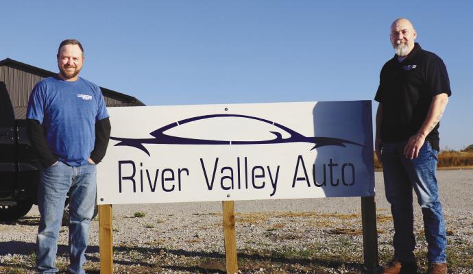 RIVER VALLEY AUTO opened its new facility north of St. Paul in mid-October. Pictured in front of the dealership’s new offices, detailing shop, and car lot are Marcus Paczosa and Luke Stange.