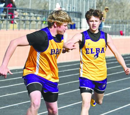 ELBA’S ZACHARY LECH makes an exchange with Bladen Rathman during the boys’ 4x400-meter relay on Thursday in Loup City. The Bluejays placed ninth in that event. Photo by Michael Happ