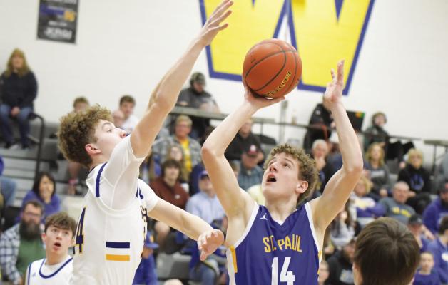 ST. PAUL sophomore Jack Thede attempts to put up a shot during the final minutes of last week’s district final basketball game between St. Paul and Wahoo. The Warriors topped the Wildcats 79-15, ending St. Paul’s season. (Michael Happ)