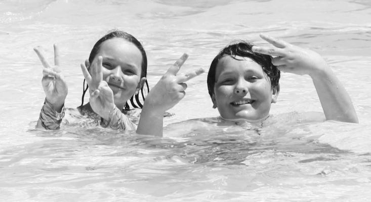THE ST. PAUL WATER PARK was the perfect place to cool off on Monday, the facility’s fourth day in operation for the 2025 swim season. Above, a pair of excited swimmers pose for a photograph while enjoying the water at the water park. Photo by Michael Rother
