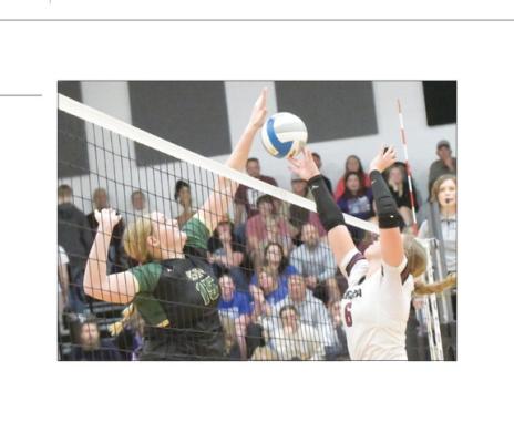 CENTURA’S KASSIDY HURT goes for a kill opposite Central City’s Hope Paup during last Thursday’s Lou-Platte Conference championship match at Centura High School. Photo by Michael Happ