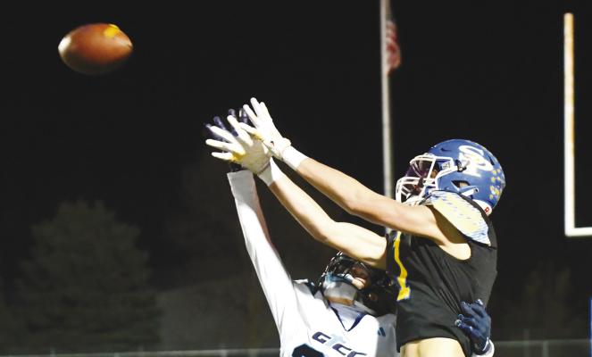 ST. PAUL’S JAYDN THOMSEN reaches for a pass during the second quarter of last Friday night’s regular season finale against Grand Island Central Catholic. The Wildcats bested the Crusaders 48-33. Photo by Jordan Coslor