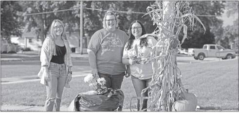 OFFICIALS at the Howard County Courthouse got into the fall spirit earlier this month when they took some time on a Friday evening to decorate one of the light poles outside the courthouse as a part of the St. Paul Area Chamber of Commerce’s Pole Decorating Contest. Pictured assisting with the after-hours project are Mykenna Sorgenfrei, Jennifer Ostendorf, and Sara Roy. Photo by Michael Happ