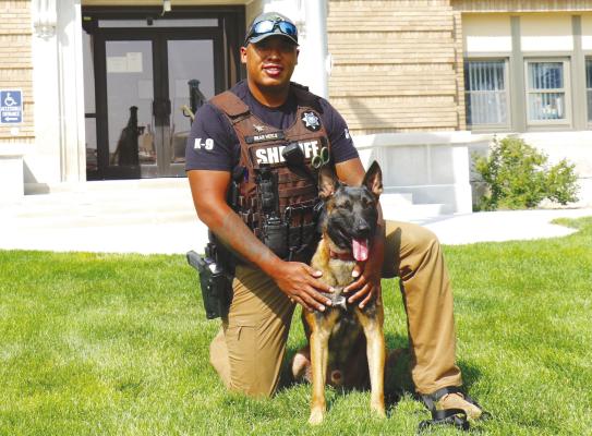 HOWARD COUNTY SHERIFF’S DEPUTY Malik Bearheels is pictured outside the Howard County Courthouse with the department’s new police service dog. Photo by Michael Rother