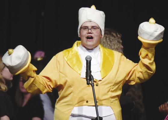 JOSEF KASLON was the Candlestick during a performance of Be Our Guest, which was the opening number of St. Paul High School’s variety show on Saturday night. Photos by Michael Happ