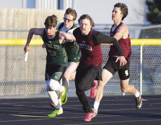 CENTURA’S Keaton Lemburg hands off the baton to Jason Fanta during the second exchange of the boys’ 4x100-meter relay on Friday evening. The Centurions won that race in 44.96. (Michael Happ)