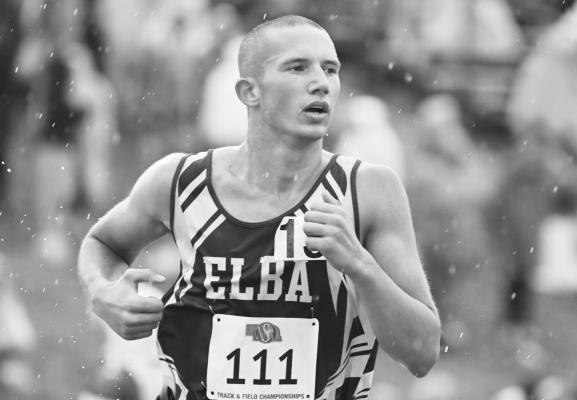 ELBA’S BLAKE BARG was forced to battle some of the toughest conditions of the NSAA Class D State Track and Field Championships when he competed in the boys’ 3200-meter run at last week’s state meet. Photos by Michael Happ