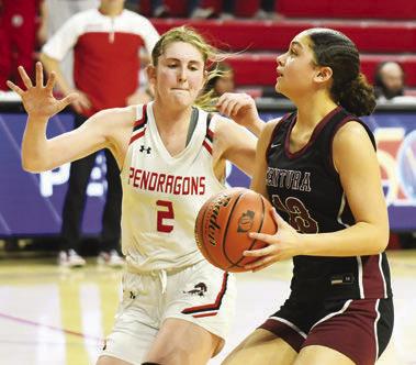 BELLE TAUKIUVEA drives into the paint against Pender’s Hadley Walsh. Photos by Jordan Coslor