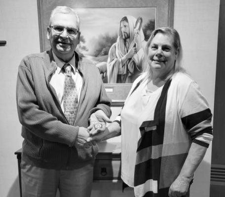 JAMES (JIM) BARTEL of St. Paul was presented a United States Navy Forgotten Warrior Honorary Coin by Nadine Bane at the Zion Lutheran Church Thanksgiving meal on Wednesday evening. Bartel is a former United States Navy Vietnam Veteran. Courtesy Photo