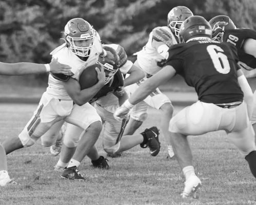 WILDCAT QUARTERBACK ALEX MEINECKE finds a hole in the Mustangs’ defense during last Friday night’s game between St. Paul and Raymond Central. Photos by Michael Happ