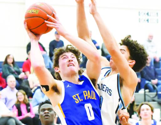 ST. PAUL sophomore Gage Sack muscles past a Grand Island Central Catholic defender on his way to the rim last Friday night. The Crusaders topped the Wildcats 41-33. (Jordan Coslor)