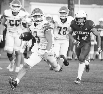 ST. PAUL QUARTERBACK ALEX MEINECKE sprints into the open field during the first quarter of Friday night’s football game against Amherst. The Broncos bested the Wildcats 28-6. Photos by Michael Happ