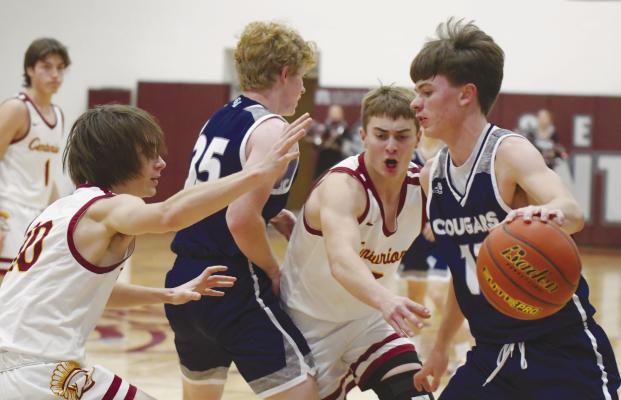 TAE SOTO drives into the lane during the first quarter of last week’s game between the Cougars and the Centurions. Soto had twenty-two points in the contest. Photos by Michael Happ