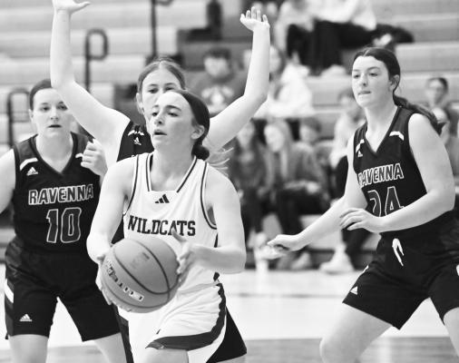 ADDY WEGNER fights her way to the basket during the first half of last Tuesday night’s game aginst Ravenna. Wegner had six points in the Wildcats’ victory over the Bluejays. Photos by Michael Happ