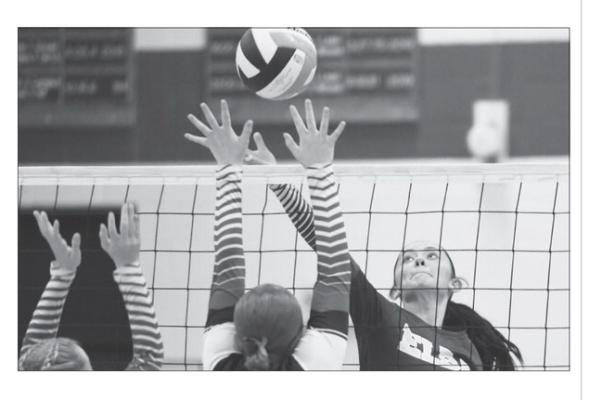 JARAHLYNN MORROW goes for a kill opposite a Fullerton defender during last week’s triangular with the Warriors and Palmer.