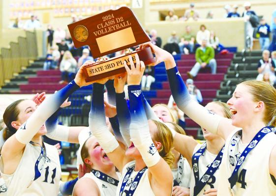 COUGAR VOLLEYBALL PLAYERS celebrate Saturday’s third place finish at the NSAA State Volleyball Tournament by hoisting the third-place trophy. Central Valley bested Overton 3-1 in the bronze-medal bout. Photos by Jordan Coslor