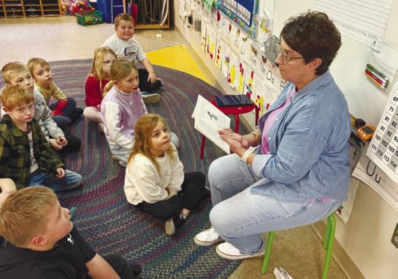 ST. PAUL ELEMENTARY first grade teacher Kellie Seward reads to students as a part of St. Paul Elementary’s One School, One Book program. Students from Kindergarten through sixth grade in the district take part in the program. Courtesy Photos
