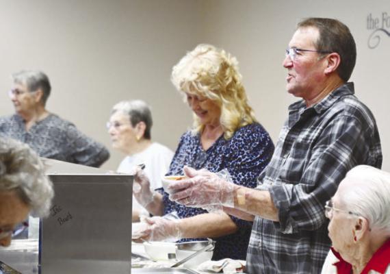 VOLUNTEERS helped man the serving line at the St. Paul Senior Center’s soup fundraiser on Sunday. Pictured lending a hand are Kathy Hirschman and Chris Townsend. Photos by Michael Happ