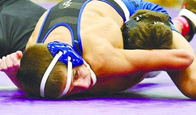 HEUSTYN ROESLER capped off St. Paul’s dual against Mitchell with an eighteen-second pin at 106 pounds on Friday night. The Wildcats topped the Tigers 45-35. Photos by Michael Happ