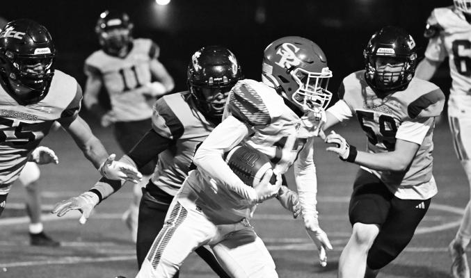 JACKSON WEGNER attempts to pick up yards following an interception during the second quarter of last Friday night’s game against Grand Island Central Catholic at Memorial Stadium. Photos by Michael Happ