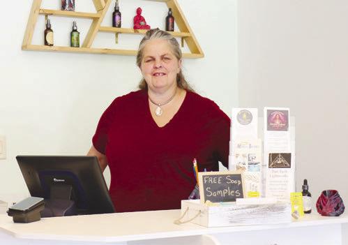 KATANA RAY stands behind the counter of Running Wolf Originals’ new storefront shop in St. Paul last week. The St. Paul location officially opened on June 19th. Photo by Michael Rother