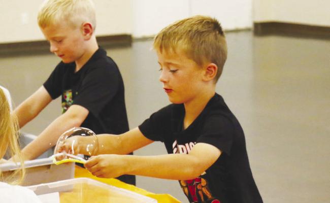 KIDS OF ALL AGES got the opportunity to learn a bit about cell membranes as part of St. Paul Summer Rec’s Summer Science programming last Wednesday, June 17th. Pictured are Greyson Knapp and Jack Meyer. Photos by Michael Rother