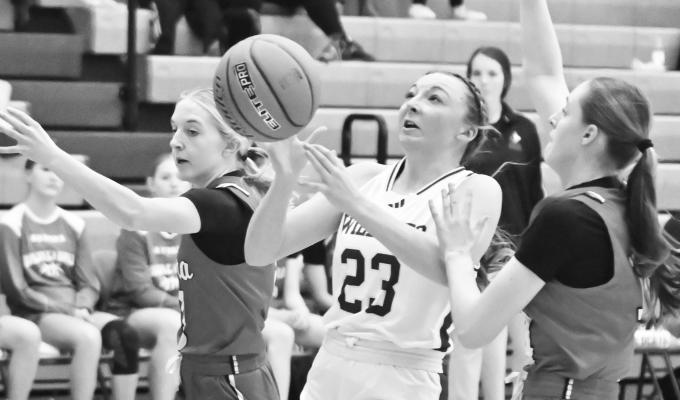 ST. PAUL’S CHARLEE WEGNER drives to the basket during the second quarter of last Thursday night’s game against Aurora. The Wildcat finished the contest with eight points and seven rebounds. Photos by Michael Happ