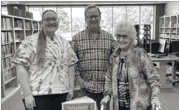 Rasmussen donates book to library
