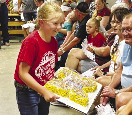 TATUM STEVENSON shows off her cake during Sunday afternoon’s cake auction at the Howard County Fair. Photos by Michael Happ