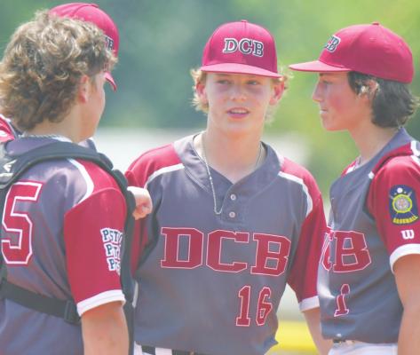 DANNEBROG-CAIRO-BOELUS’S Nolan Hurt, Mason Gorecki, and pitcher Cade Ruhl held a meeting on the mound during the first inning of Saturday afternoon’s game against St. Paul. (Michael Happ)