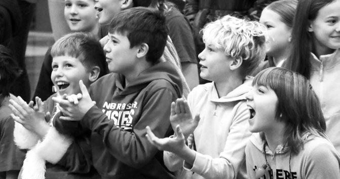 STUDENTS at St. Paul Public Schools had plenty to cheer for on December 19th, the last day of classes for the Howard County school district prior to the start of the winter break. Elementary students had the chance to cheer on the Grinch and Santa Claus during their annual pre-holiday wrestling match, with the Candy Cane Crusher also making an appearance during the event this year. Photos by Michael Rother