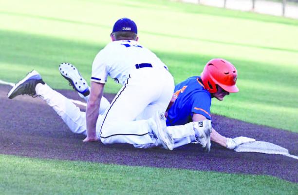 MASON MAJERUS slides under the tag, thwarting the Dukes’ effort to pick the Cat off first base on Friday afternoon. York beat St. Paul/Palmer 2-1 in eight innings at Levitt Stadium.