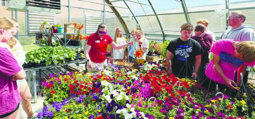 NEBRASKA EXTENSION EDUCATOR ELIZABETH EXSTROM speaks to St. Paul Public School students in the school’s greenhouse prior to the FFA plant sale earlier this year. Courtesy Photos