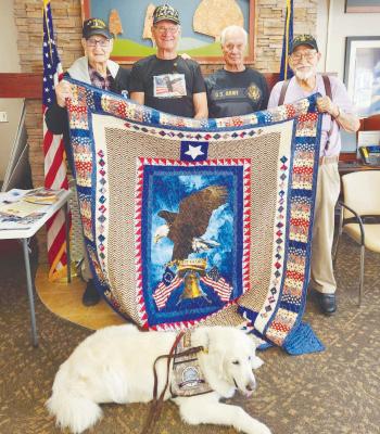 CARL MOGENSEN AMERICAN LEGION POST MEMBER JERRY SCHENCK was recently awarded a Quilt of Valor at a ceremony at the Grand Island VA Medical Center, accompanied by his brothers. Pictured at the ceremony are (left to right) Dan, Jerry, Harold, and Earl; and (below) Eddie the comfort dog. Courtesy Photo